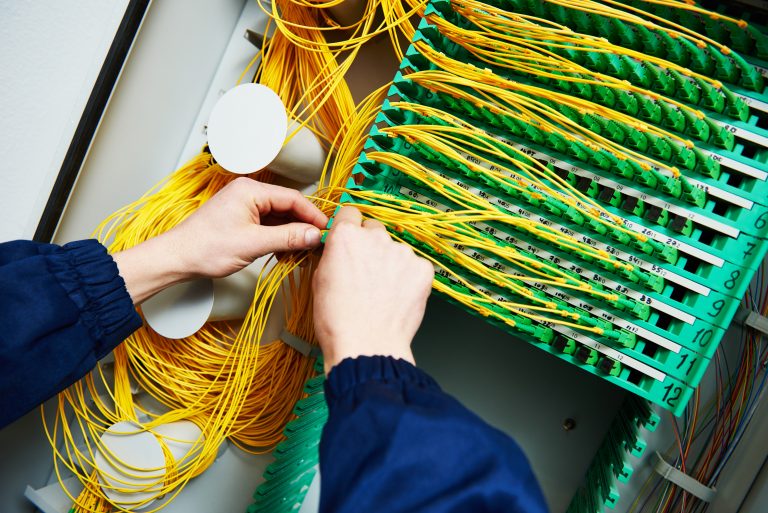 internet connection. technician engineer hands connecting fiber optic cables