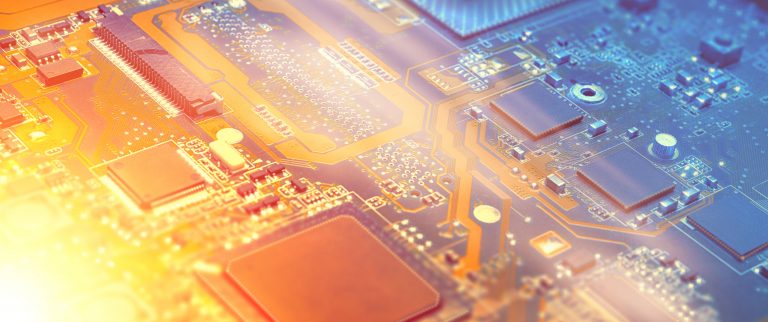 Closeup on electronic motherboard card in hardware repair shop. Blurred panoramic image with details of the circuitry and close-up on electronics. Filtered picture toned in orange and blue, copy-space